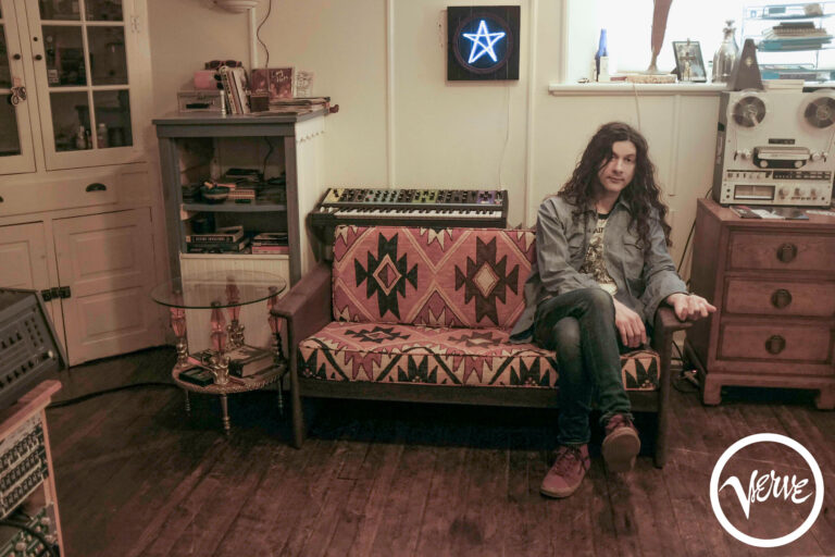 Promotional image of Kurt Vile on sofa who will be appearing at Manchester Psych Fest