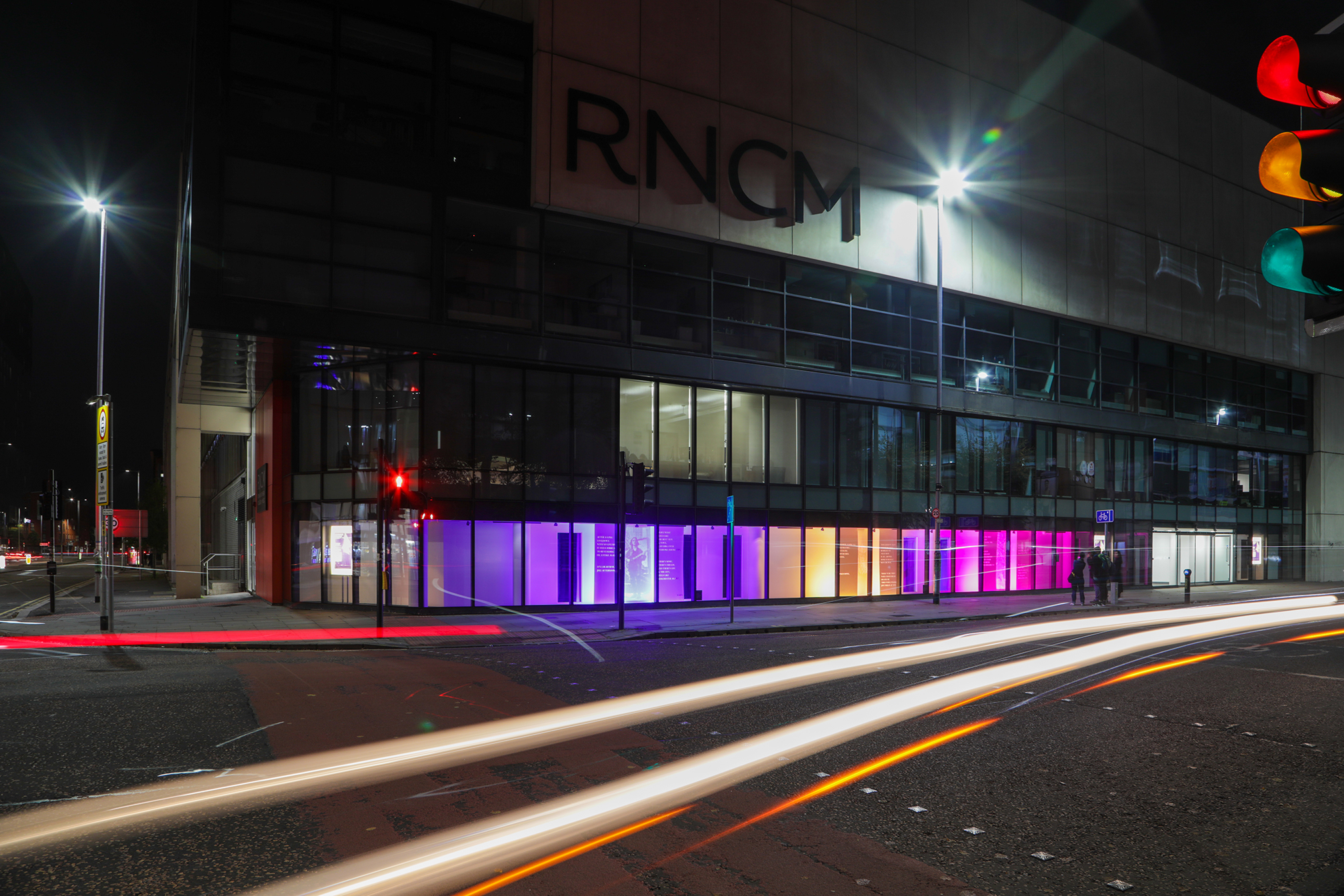 Windows of RNCM lit up at night for Many Types of Graces
