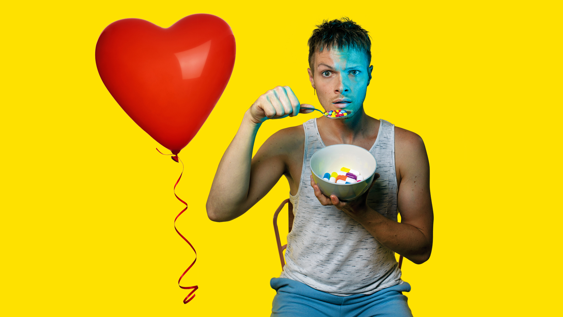 Actor Nathan Hall with a bowl of pills in the promotional image for DIBBY THEATRE: FIRST TIME