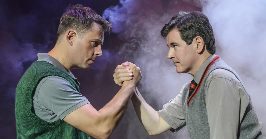 Two brothers shake hands in blood brothers at palace theatre manchester oxford road corridor