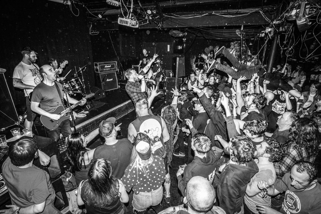 A busy audience with crowd surfers at Manchester Punk Festival